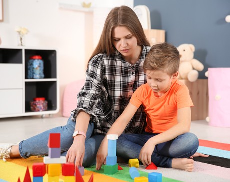 AST-young-girl-playing-with-toys-in-her-room - Wisconsin Early Autism  Project (WEAP)