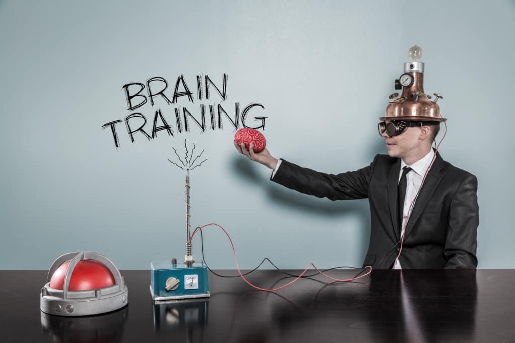 Brain training concept with businessman holding brain