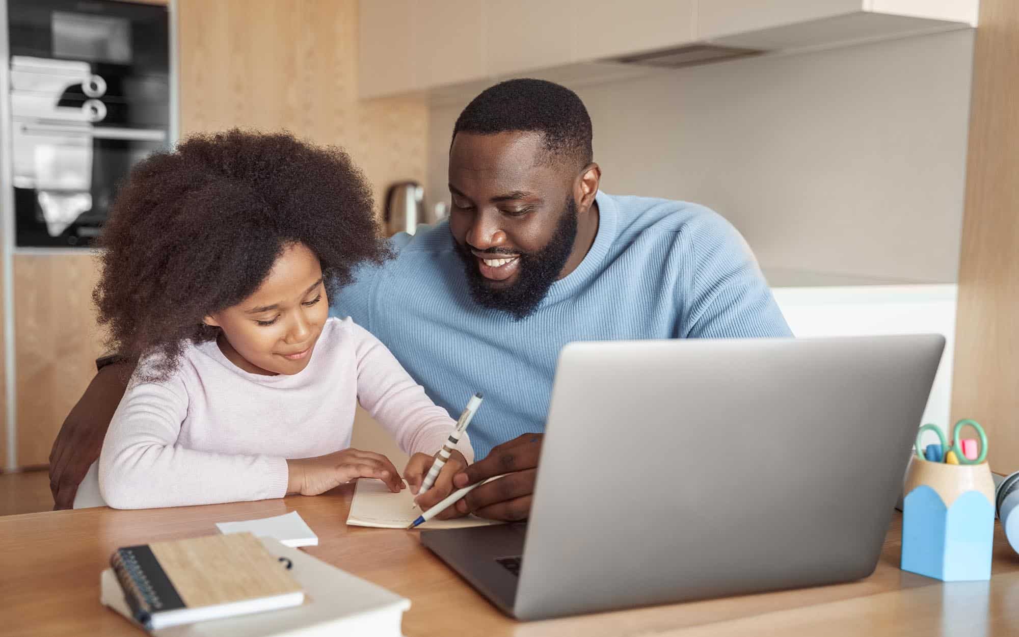 Parent helping their child with online learning