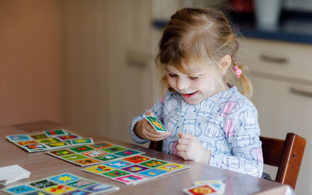 Small child playing with memory training game