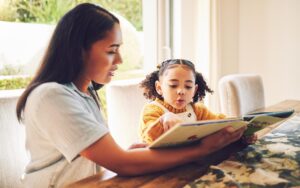 Parent reading book with child