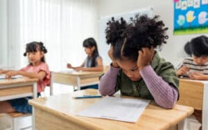 girl student doing an exam at elementary school