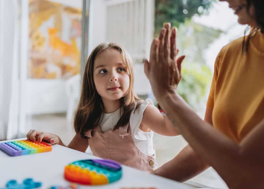 Mother playing with autistic daughter