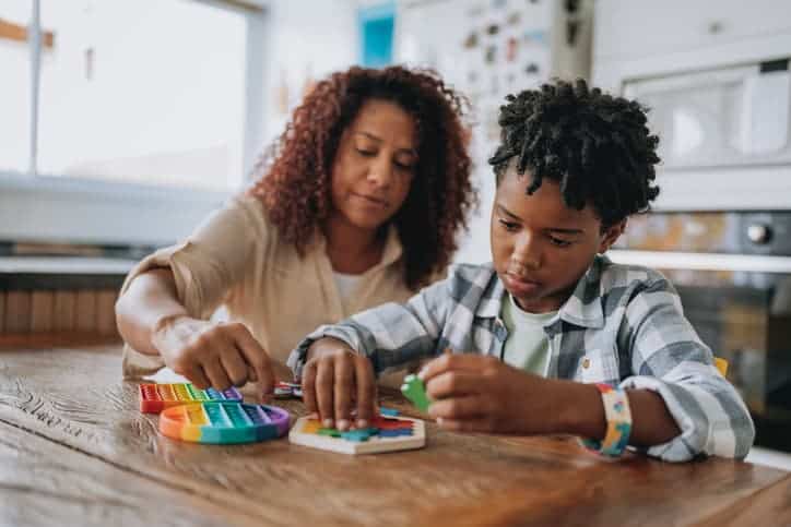 Mother playing with autistic son